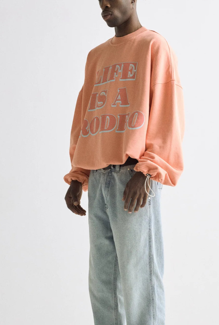 UNDERGOLD: LIFE IS A RODEO CREWNECK (side view on model)