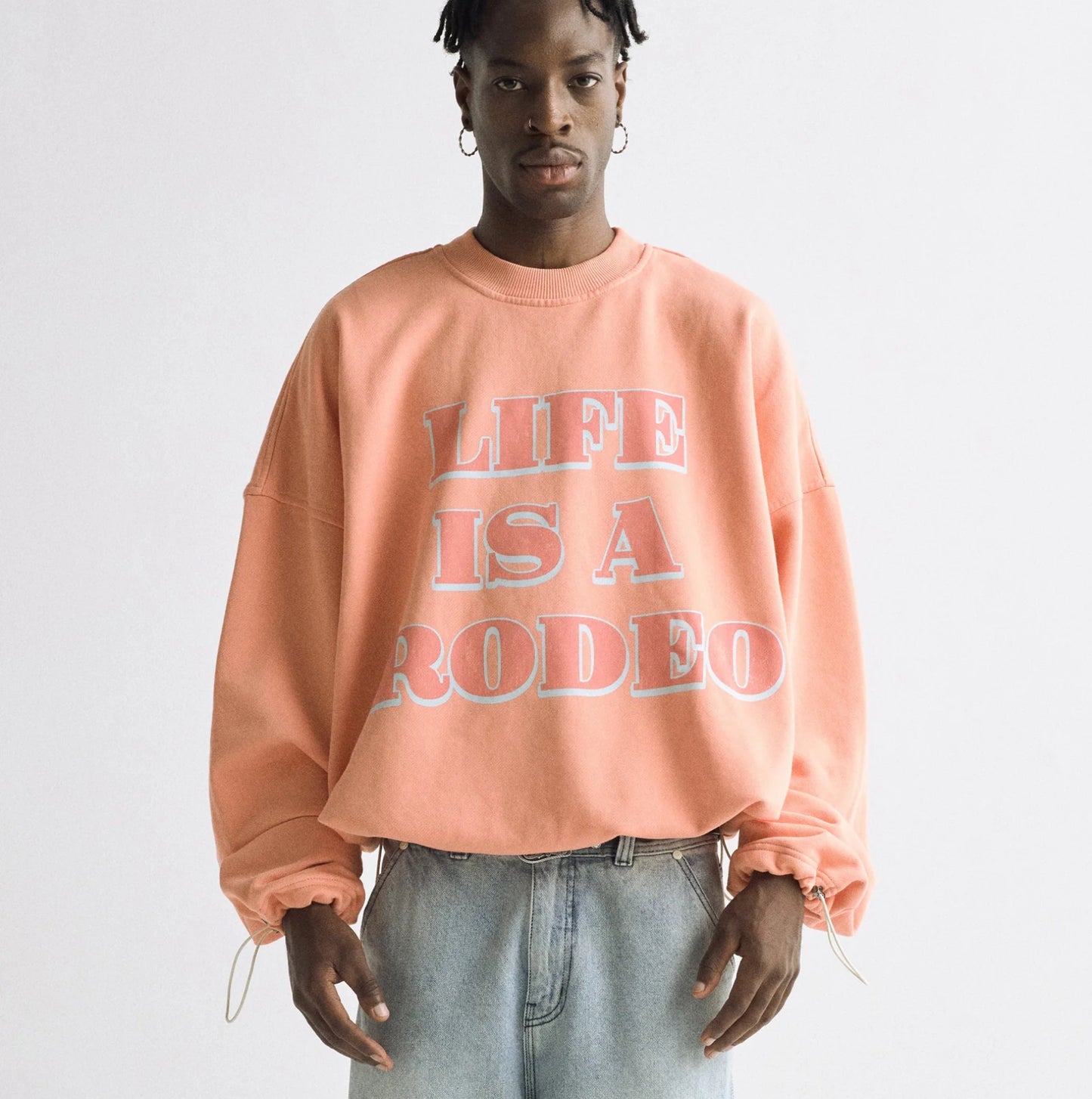 UNDERGOLD: LIFE IS A RODEO CREWNECK (front view on model)