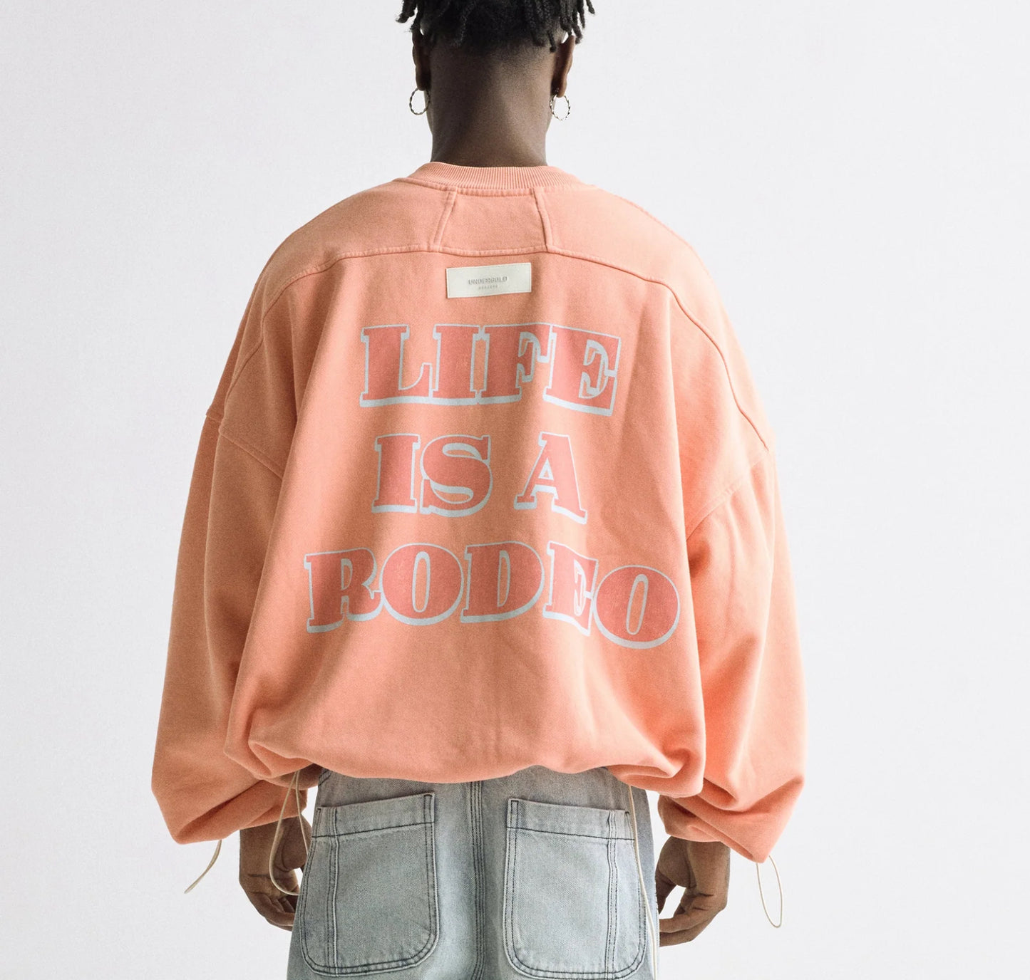 UNDERGOLD: LIFE IS A RODEO CREWNECK (back view on model)