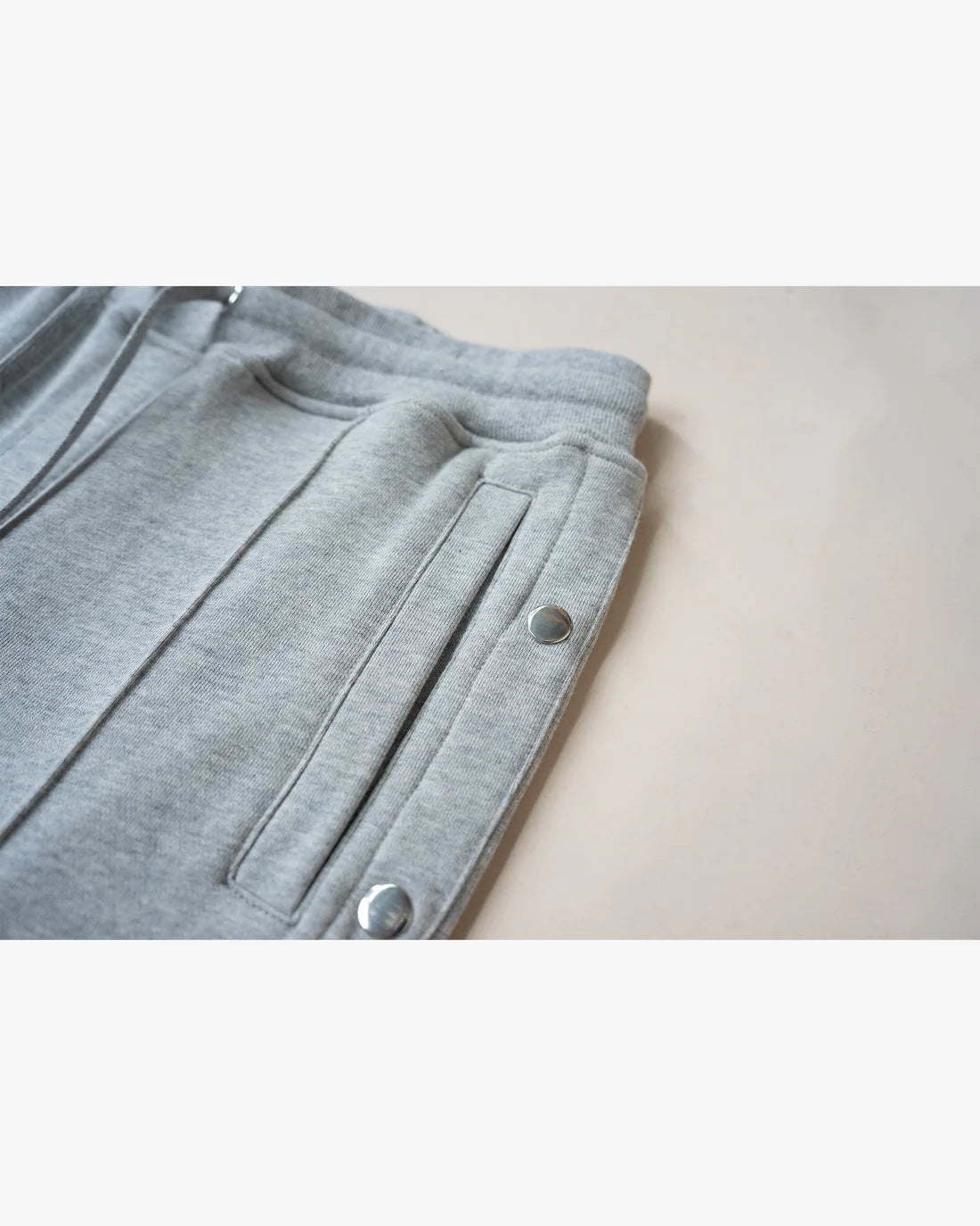 EPTM: FRENCH TERRY SNAP FLARED PANTS GREY (up close flat lay view)