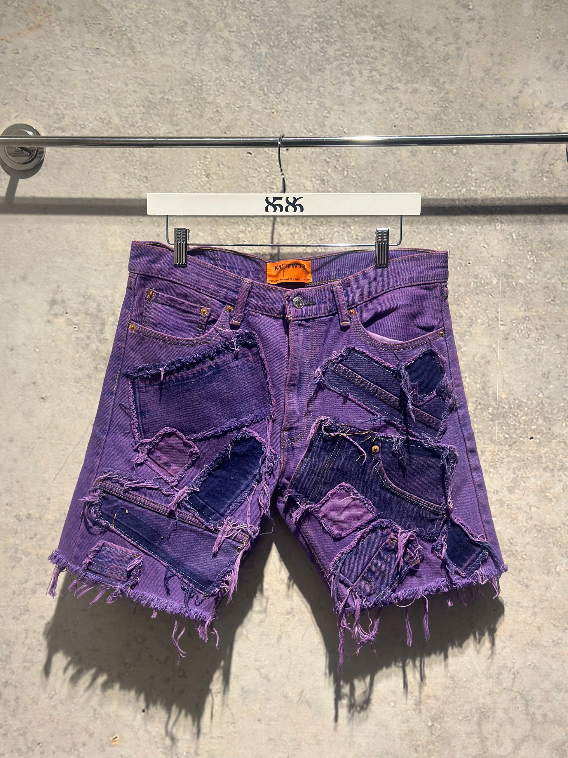 KNOTWTR: PATCHWORK DENIM SHORTS (purple front view’